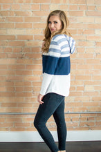 Load image into Gallery viewer, Model showing side view of striped hoodie.