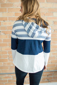 Model showing back view of striped hoodie.