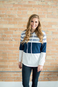 Model smiling wearing striped hoodie